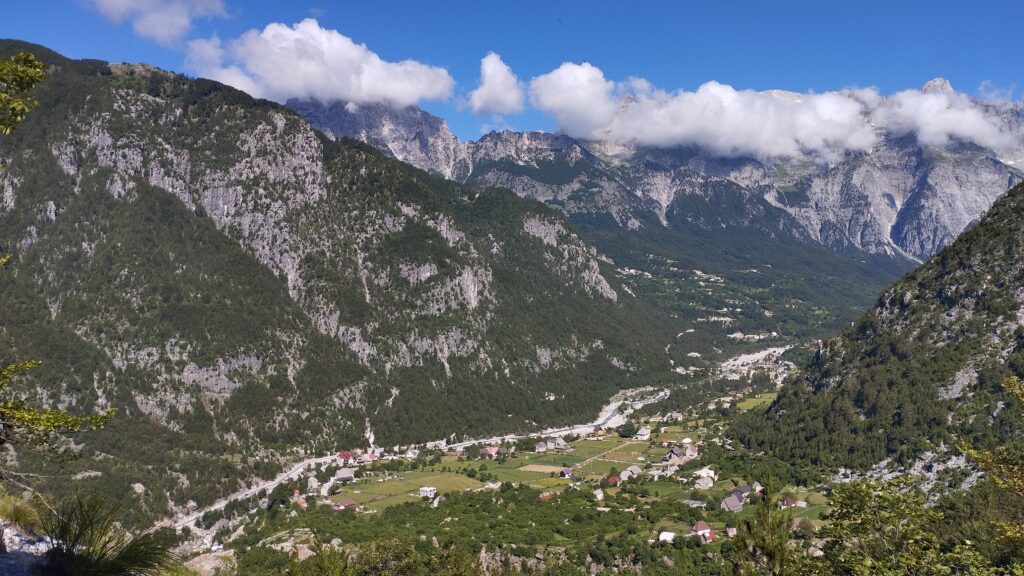 Theth valley surrounded by Albanian Alps mountains on a clear summer day