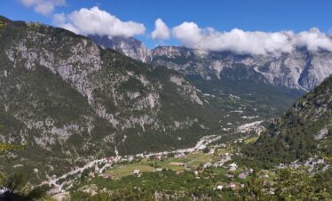 Theth valley surrounded by Albanian Alps mountains on a clear summer day